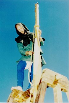 John applies a protective coating of oil to the beam.... photo by Dick Stein