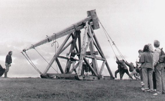 A weight and human powered trebuchet in action