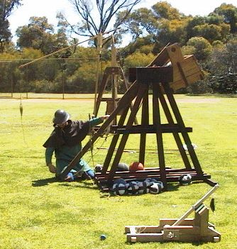 Poor broken Frankentreb stands behind the other, working trebuchets.... photo by Dick Stein